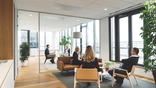 people gathered and discussing in an office meeting room